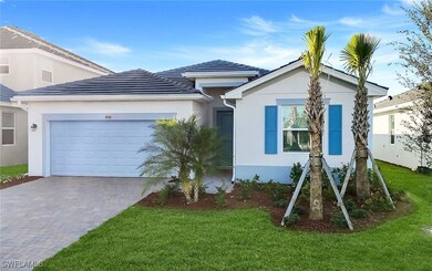 View of front of property with stucco siding, an attached garage, a front yard, and decorative driveway