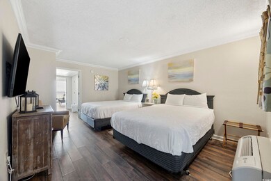 Bedroom featuring ornamental molding, a textured c