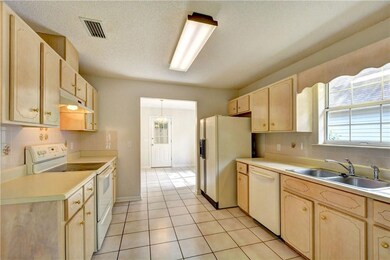 The kitchen opens to the dining area on one end an