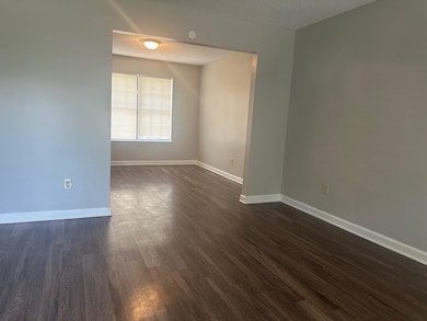 Empty room featuring dark wood finished floors and a textured ceiling