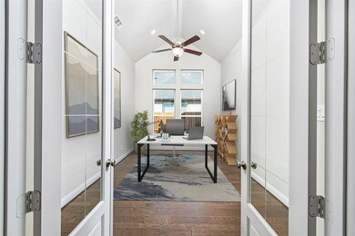 Dramatic cathedral ceiling and french doors in study