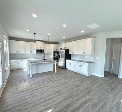 Kitchen with a sink, stainless steel appliances, w