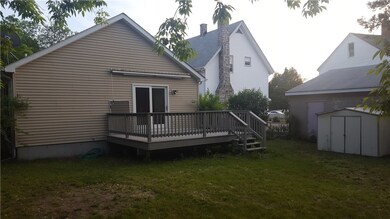 Rear of home deck with with slider and roll out aw