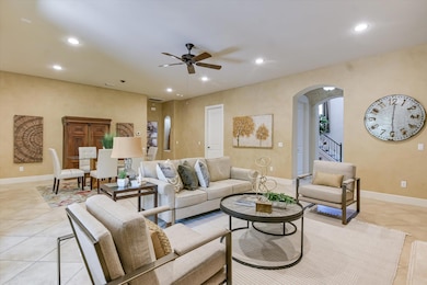 Living area featuring arched walkways, recessed l