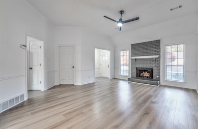 Unfurnished living room featuring lofted ceiling, 