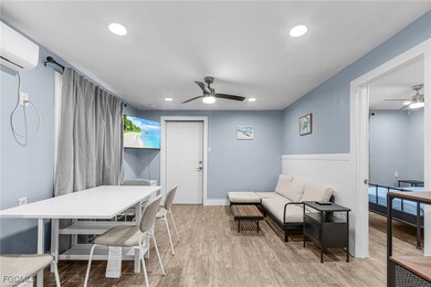 Dining space with a ceiling fan, light wood finished floors, recessed lighting, and an AC wall unit