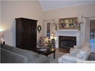 Another view of den shows the fireplace and vaulte