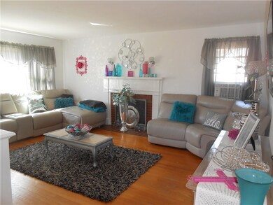Large living room with wood burning fireplace.