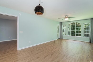 Empty room featuring ceiling fan, wood finished floors, and a smoke detector