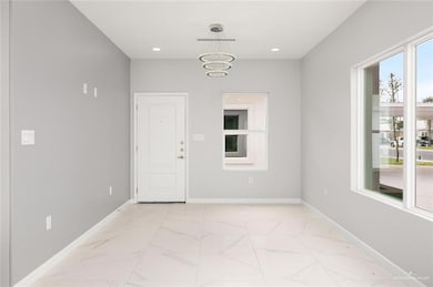 Unfurnished room with an inviting chandelier