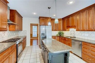 Upgraded kitchen w/ tile backsplash, gas range w/ stainless steel appliances.  Cabinets and countertop space galore!