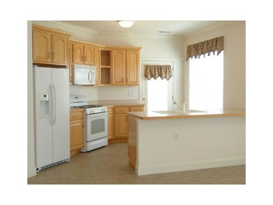 Kitchen. Warm cabinetry with overhang on counter t