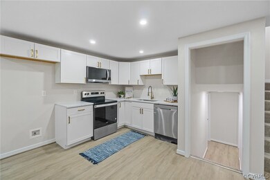 Kitchen featuring stainless steel appliances, whit