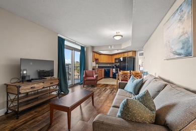 Living area with a textured ceiling, baseboards, a