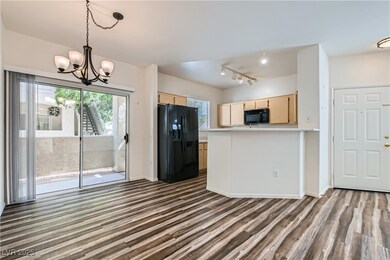 Kitchen with black appliances, light brown cabinet