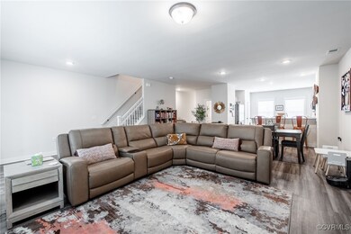 Living area with stairs, wood finished floors, and