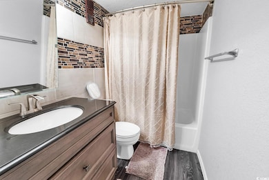 Bathroom featuring shower / bath combo, a textured