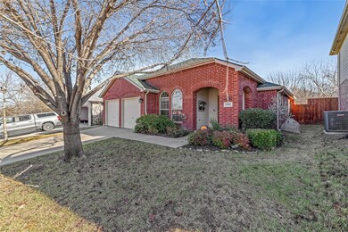 Ranch-style home with a front yard, a garage, and 