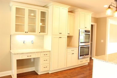 Outstanding kitchen with double ovens; gas cooktop; workstation with under counter lighting and glass front cabinets!