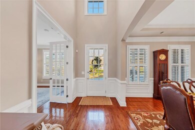 Entrance foyer featuring a wainscoted wall, orname