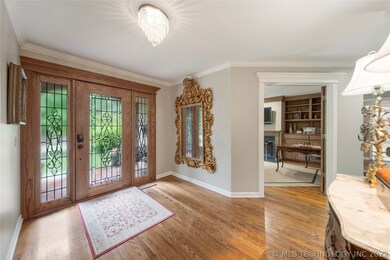 Open entry way with hardwood floors leads you in t
