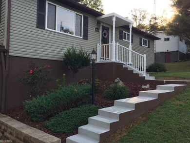 Well maintained yard with new sidewalk and railing