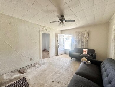 Living room with ceiling fan and carpet flooring