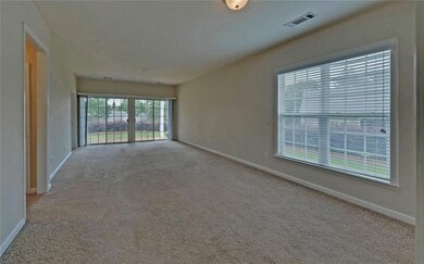 Carpeted empty room with baseboards