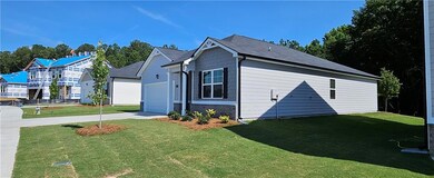 View of side of property featuring a garage and a 