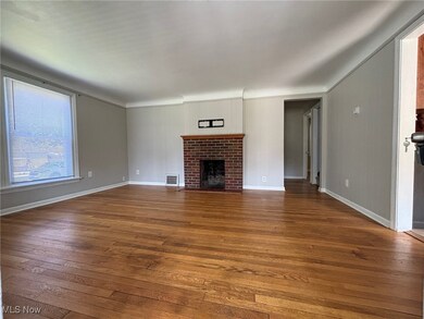 Unfurnished living room featuring a fireplace and hardwood / wood-style floors
