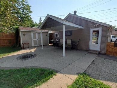 Covered patio area with convenient storage shed