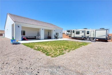 Back of property featuring a lawn