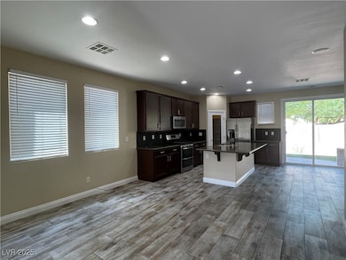 Kitchen with stainless steel appliances, dark coun