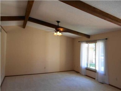 Vaulted living room with beams and lots of light. 