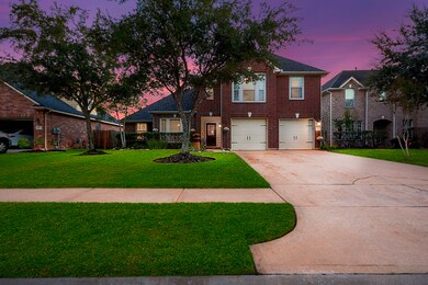 The all-brick façade features an inviting front porch design. This home includes a three-car garage and a spacious double-wide driveway for additional parking or to appreciate the front yard.