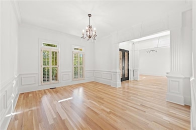 Empty room with a chandelier, a decorative wall, c