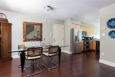 Dining room and kitchen. Door is garage access.