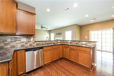 Open kitchen with granite and beautiful backsplash
