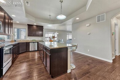The Island Kitchen has a counter bar with pendant 