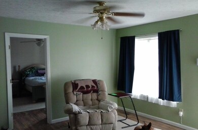 View of living room with newer floors Couch and chair stay