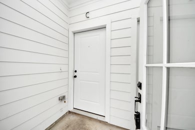 A recessed, covered entryway adds privacy and clea