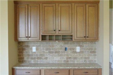 additional built in home/office space with granite tops and tile backsplash