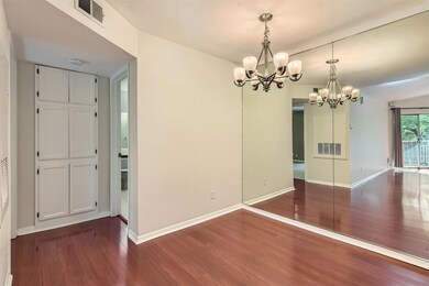 Unfurnished dining area with a chandelier and dar
