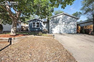 View of front of house featuring concrete driveway and an attached garage