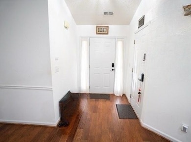 Entrance foyer featuring wood finished floors and 