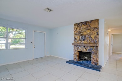 Unfurnished living room featuring light tile patte