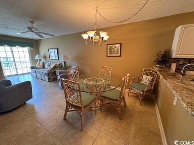 Dining room with a textured ceiling, ceiling fan, 