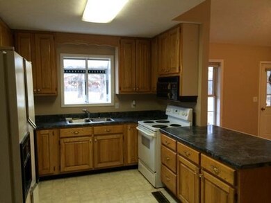 The perfect kitchen work triangle features a big bar for prepping or eating and an herb window for year round growing!