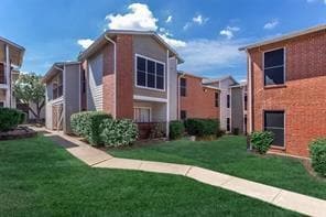 View of side of property with a lawn