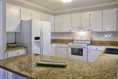 Lovely bright kitchen with granite counter tops
